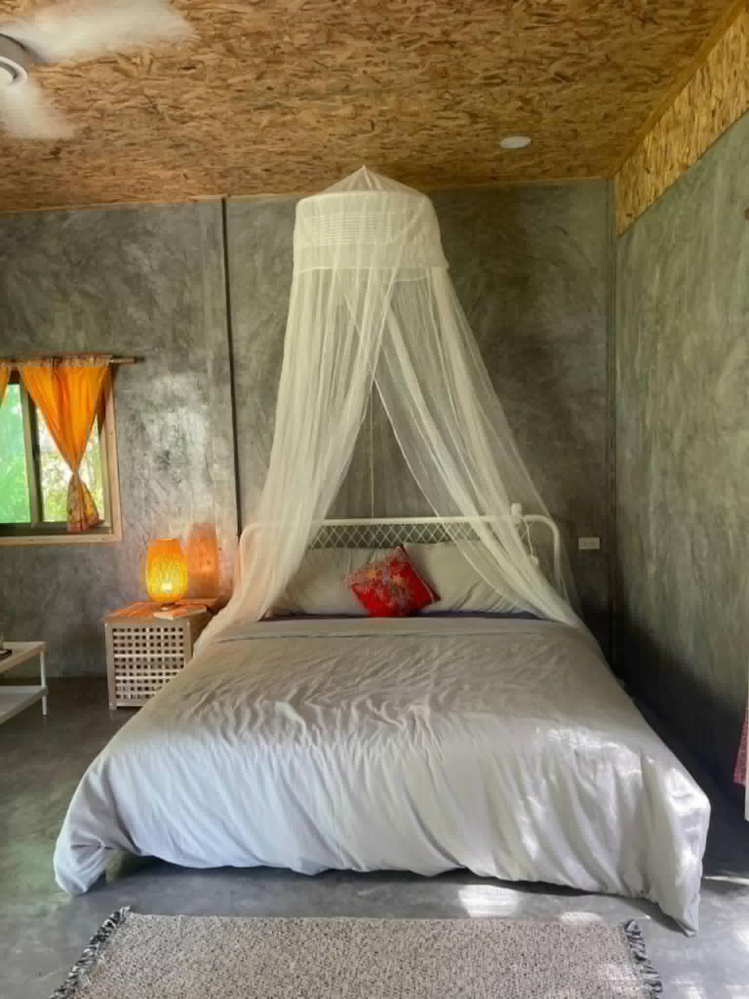 Concrete room with mosquito net canopy
