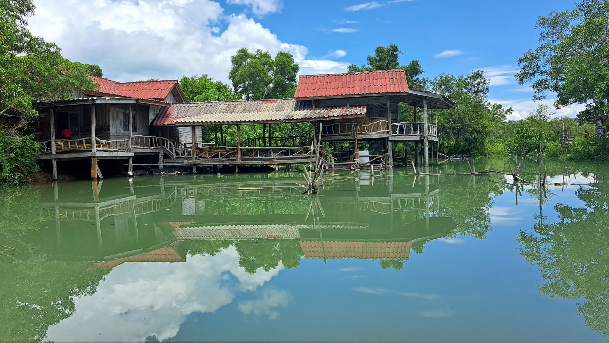 Big Hug Home stilt houses reflected in the canal